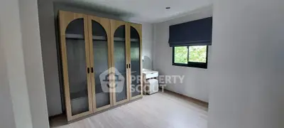 Spacious bedroom with modern wardrobe and natural light