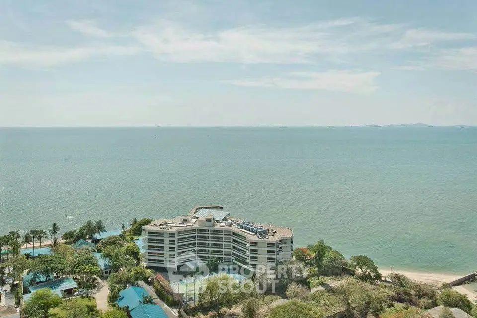 Stunning ocean view from high-rise building with lush greenery and clear blue skies.