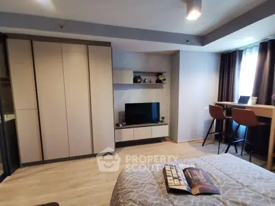 Modern bedroom with stylish decor, built-in wardrobe, and cozy workspace.