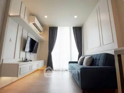 Modern living room with sleek design, featuring a wall-mounted TV, stylish sofa, and elegant curtains.