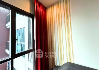Modern apartment interior with large window and stylish red curtains