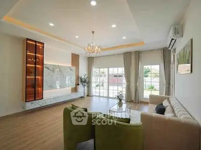 Spacious modern living room with elegant decor and large windows offering garden views.