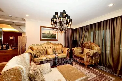 Luxurious living room with elegant furniture and chandelier, perfect for sophisticated gatherings.