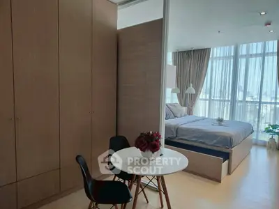 Modern bedroom with floor-to-ceiling windows and stylish decor