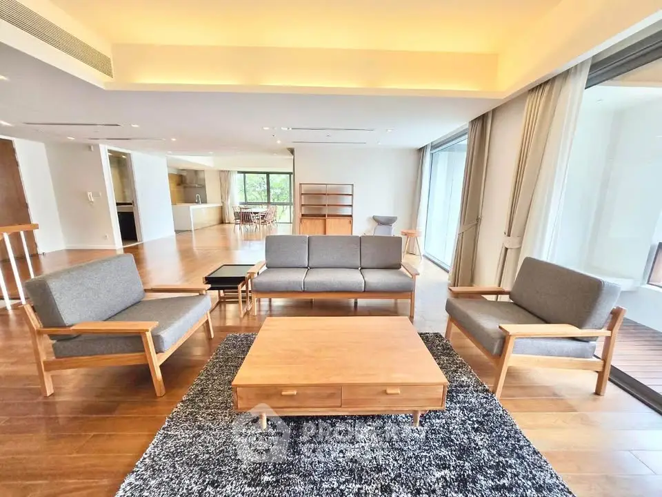 Spacious modern living room with elegant wooden furniture and large windows for natural light.