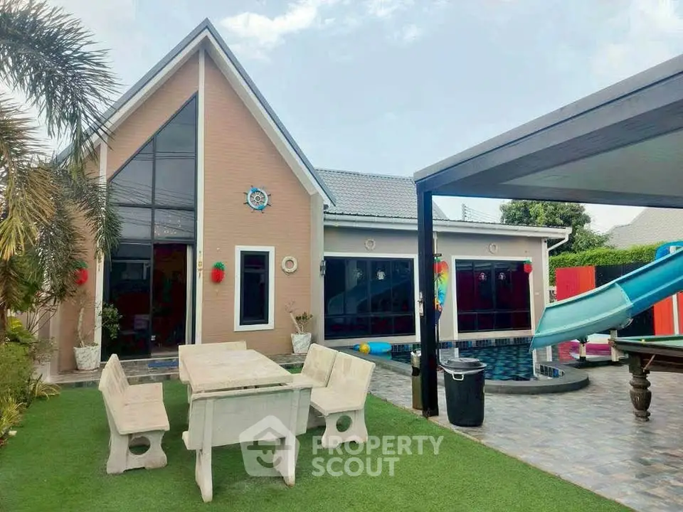 Charming modern house with pool, slide, and outdoor dining area in lush garden setting.