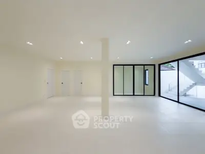 Spacious modern living room with large windows and minimalist design