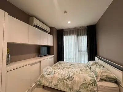 Modern bedroom with stylish decor and natural light, featuring a sleek air conditioning unit and elegant curtains.