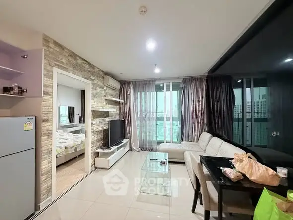 Modern living room with open layout, stylish decor, and city view from large windows.