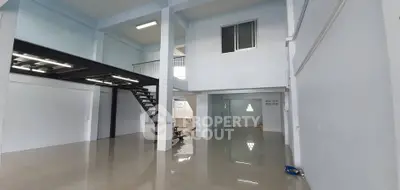 Spacious industrial-style loft with mezzanine and high ceilings, perfect for creative workspace or modern living.