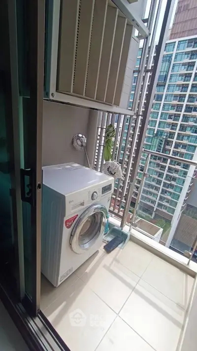 Modern balcony with washing machine and city view, perfect for urban living convenience.