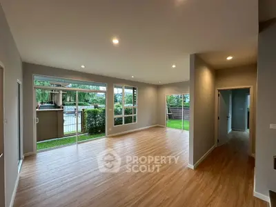 Spacious modern living room with large windows and garden view