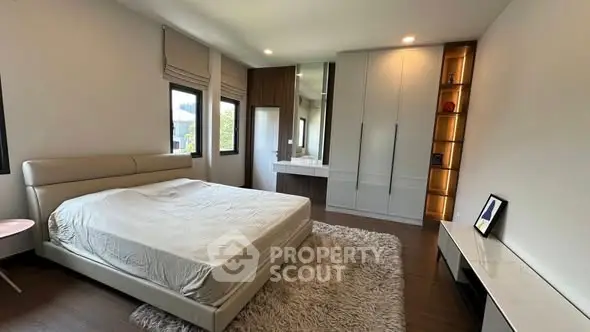 Spacious modern bedroom with large windows and stylish decor