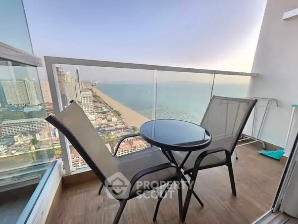 Stunning balcony view with oceanfront and cityscape, perfect for relaxation and enjoying sunsets.