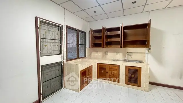 Spacious kitchen with wooden cabinets and tiled countertops