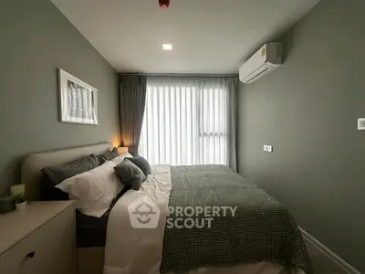 Cozy bedroom with modern decor and natural light in a stylish apartment.