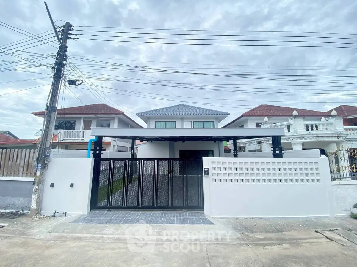 Modern two-story house with gated entrance and spacious driveway
