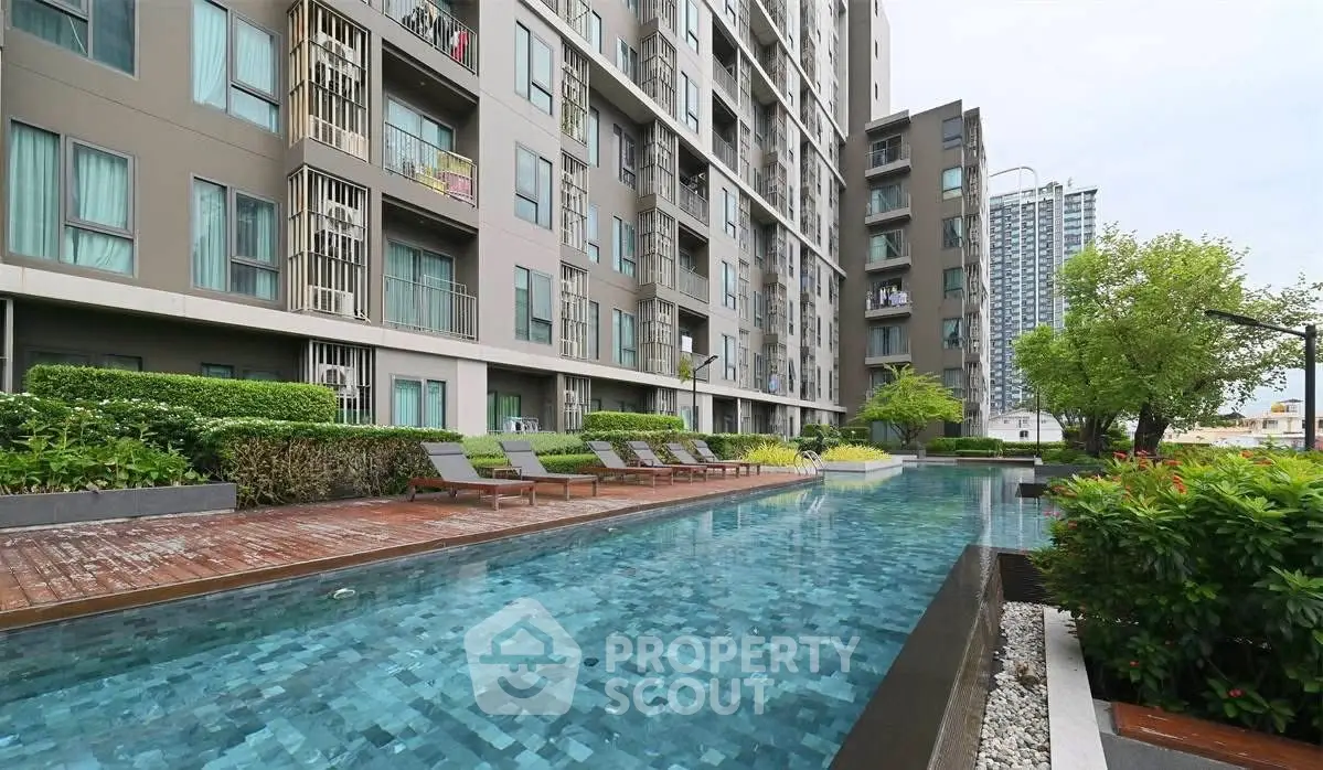 Modern apartment building with luxurious pool and lush greenery