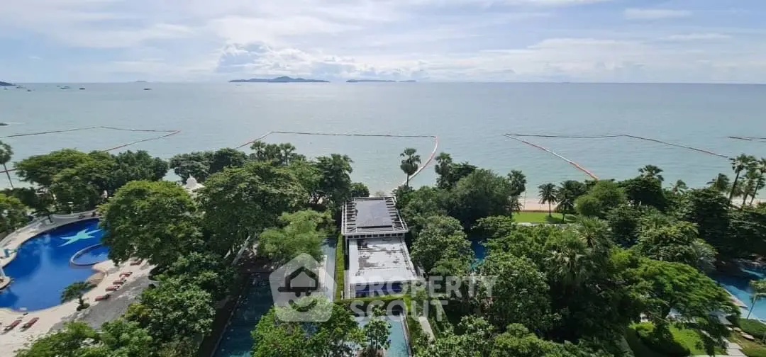 Stunning oceanfront view from a high-rise building with lush greenery and pool area.