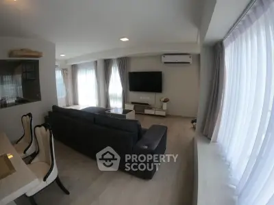 Spacious modern living room with large windows and stylish furniture