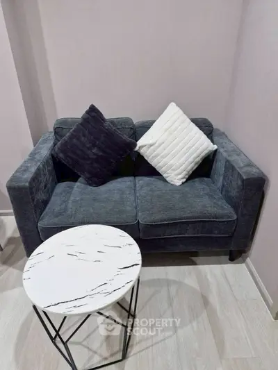 Cozy living room with stylish sofa and modern marble coffee table