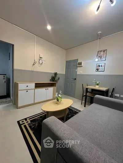 Modern living room with stylish furniture and decor in a cozy apartment setting.