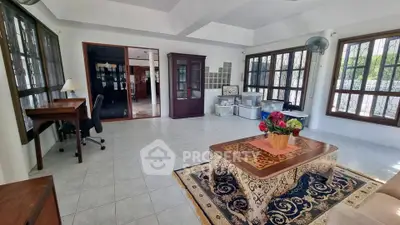 Spacious living room with large windows and elegant decor