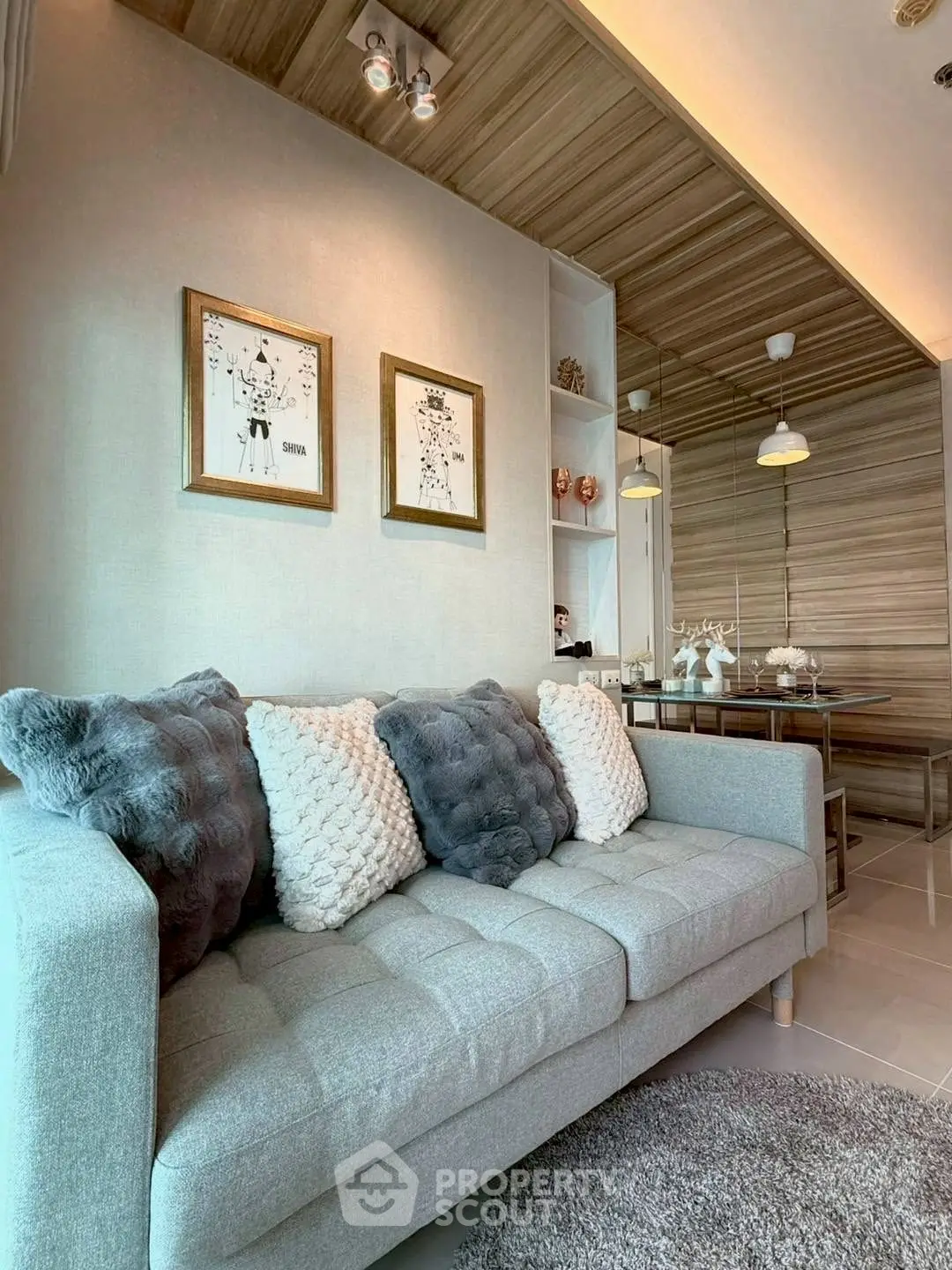Stylish modern living room with cozy gray sofa and elegant decor