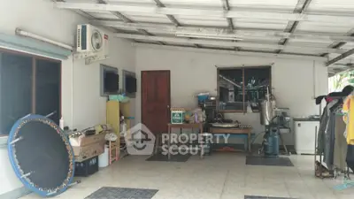 Spacious covered outdoor area with appliances and storage, ideal for versatile use.