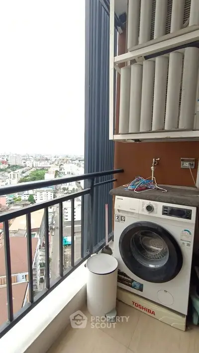 High-rise balcony with washing machine and city view, perfect for urban living convenience.