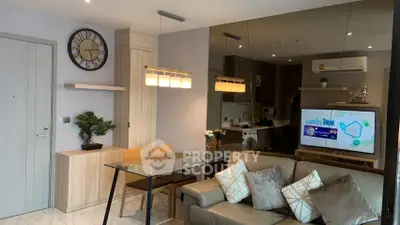 Modern living room with stylish decor and open kitchen layout in a contemporary apartment.