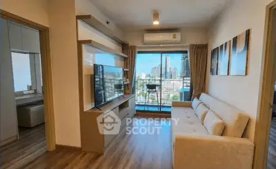 Modern living room with city view, featuring sleek furniture and large windows for natural light.