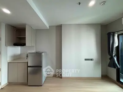 Modern minimalist kitchen with sleek appliances and ample natural light