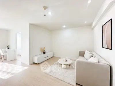 Bright and modern living room with cozy sofa and stylish decor in a minimalist apartment.