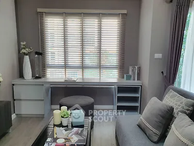 Stylish living room with modern decor and large window blinds