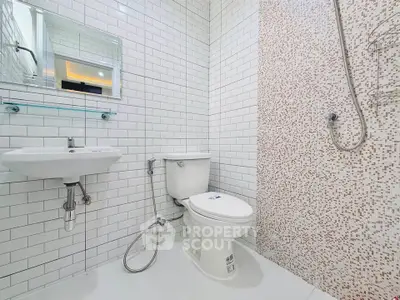 Modern bathroom with white subway tiles and mosaic shower wall