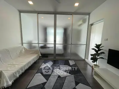 Modern living room with frosted glass partition and stylish decor