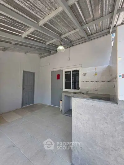 Spacious open kitchen area with modern design and ample natural light.