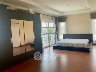 Spacious bedroom with modern design and large windows for natural light