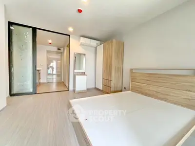 Modern minimalist bedroom with wooden furniture and sliding glass door