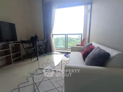 Bright living room with modern furniture and stunning balcony view.