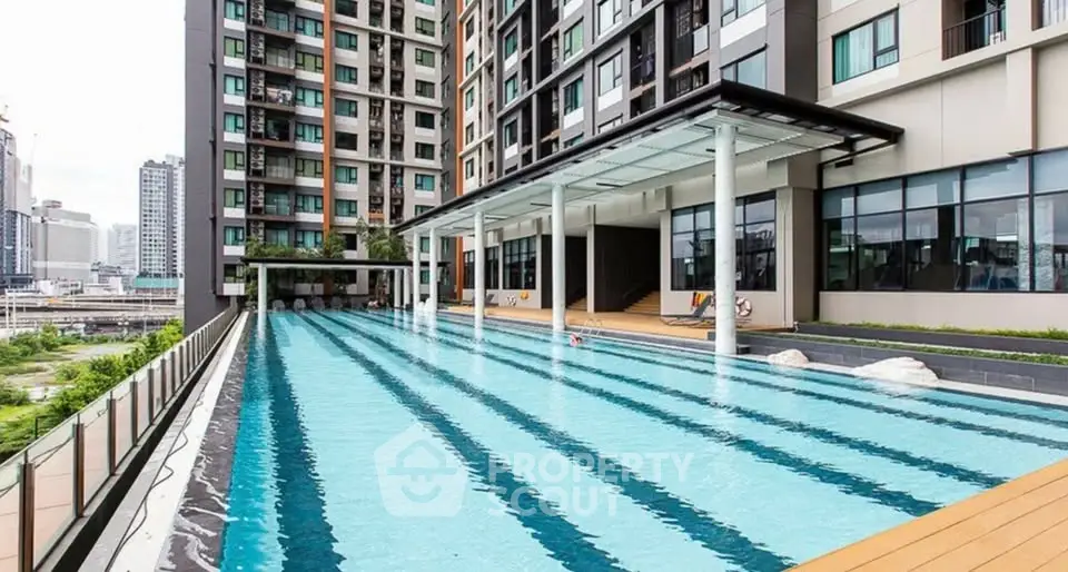 Luxurious condominium with a stunning outdoor pool and modern architecture in urban setting.