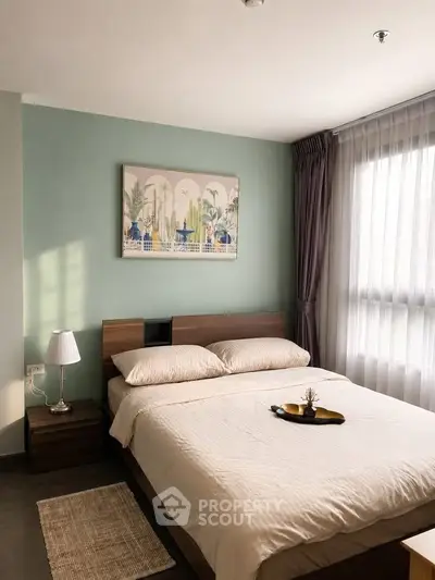 Cozy bedroom with modern decor and large window for natural light