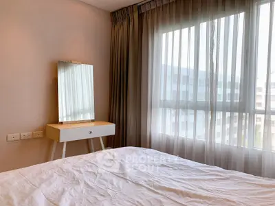 Bright bedroom with large window and modern vanity table