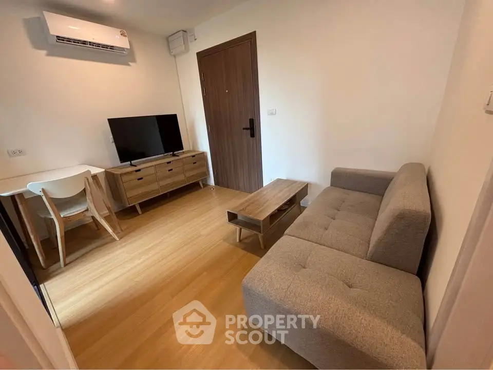 Modern living room with stylish furniture and wooden flooring in a cozy apartment.