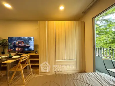 Cozy bedroom with wooden wardrobe and balcony view, perfect for modern living.