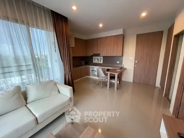 Modern living room with open kitchen and elegant furnishings in a cozy apartment.