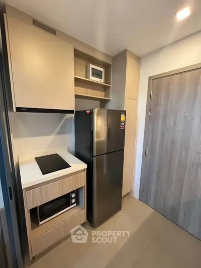 Modern compact kitchen with sleek appliances and minimalist design
