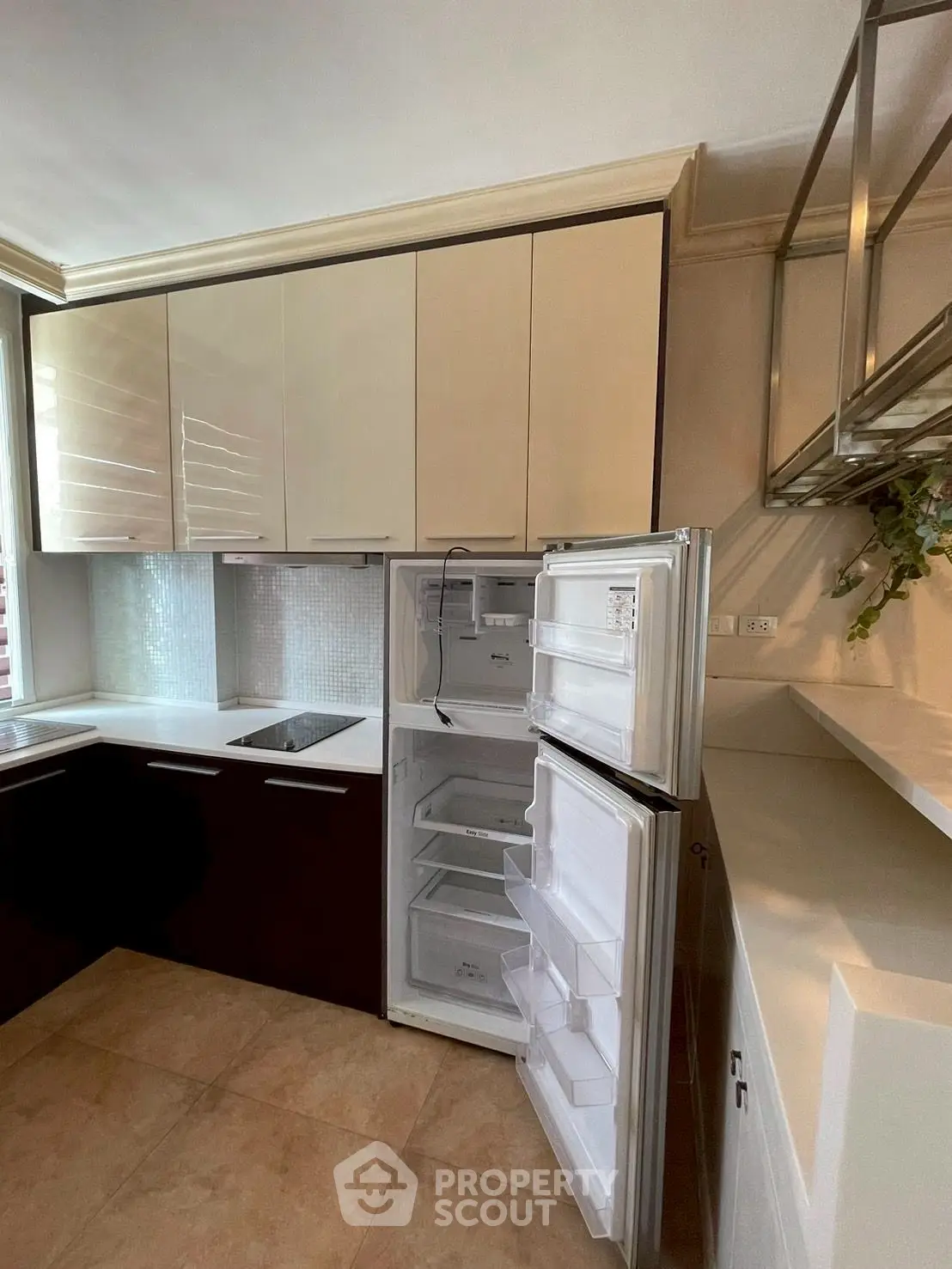 Modern kitchen with sleek cabinetry and built-in fridge in a stylish apartment
