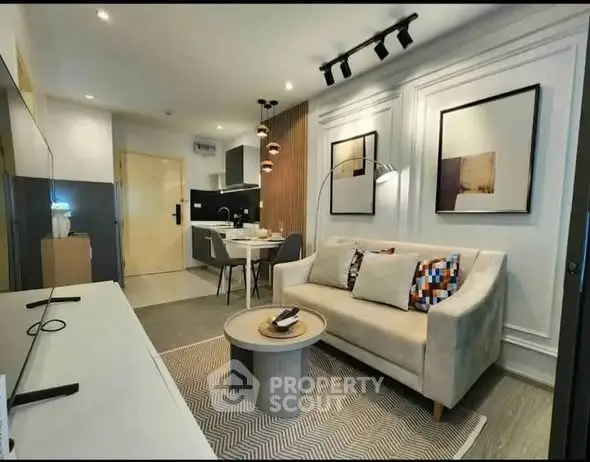 Modern living room with stylish decor and open kitchen layout in a cozy apartment.